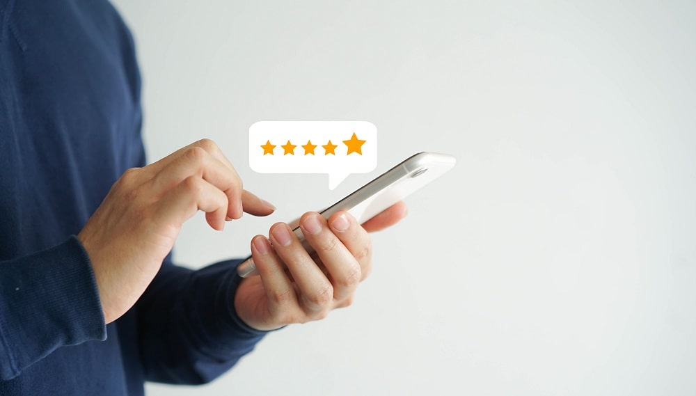 person giving a 5 star rating on their phone