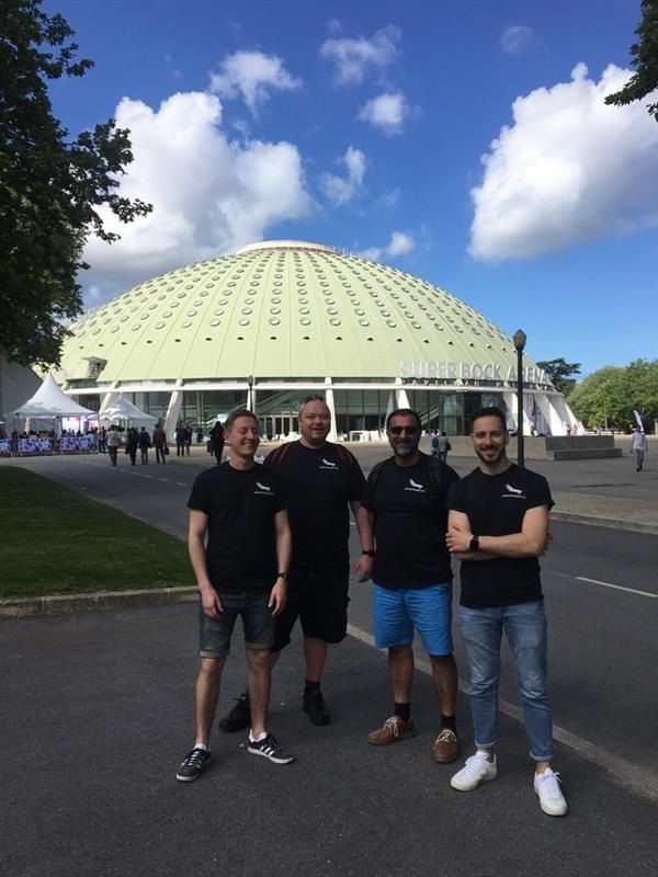 Four Americaneagle.com employees standing outside of the Super Bock Arena